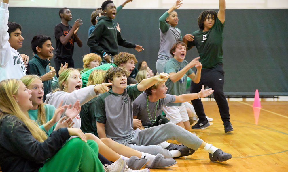 Upper school students supporting team in athletics at Tower Hill School.